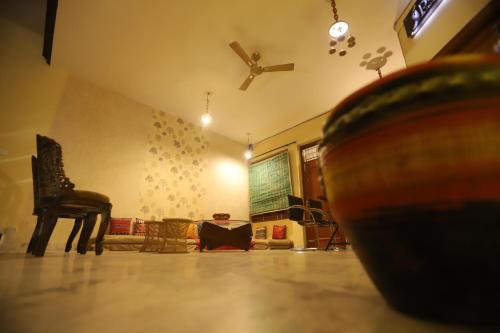 a living room with a chair and a piano at Karta-Purakh an Ayurvedic Stay in Amritsar