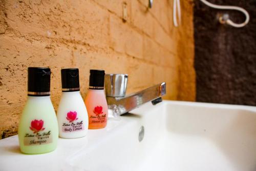 two bottles of soap sitting on top of a sink at Lotus Eco Villa in Sigiriya