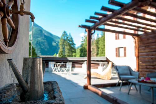 a view of a patio with a wooden pergola at Le Relais du Boucher in Gaby