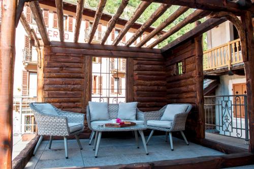 a patio with two chairs and a table on a balcony at Le Relais du Boucher in Gaby