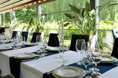 a table with wine glasses and plates on it at AQUA HOUSE in Sopot