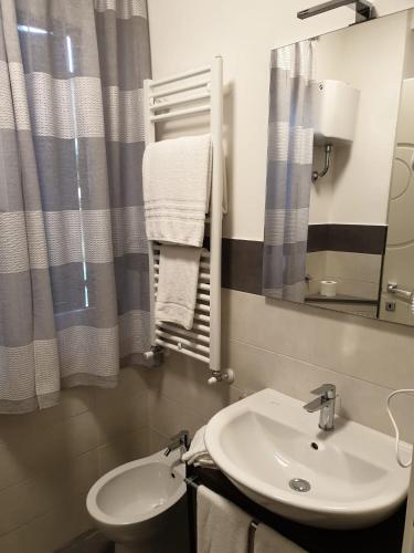 a bathroom with a sink and a mirror at B&B Le Scalette B&B San Marco in Abbadia San Salvatore