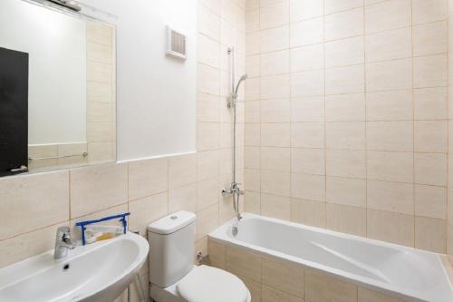 a bathroom with a toilet and a tub and a sink at Mabaat - Al Waha 19 - 377 in King Abdullah Economic City
