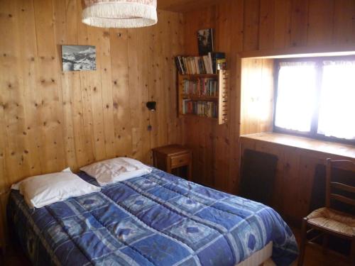 Excoffonière的住宿－Le Planay，卧室配有木墙内的一张床