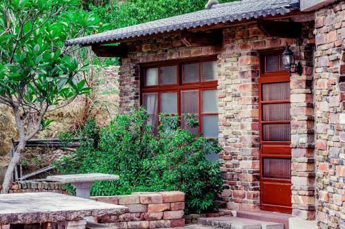 a brick building with a window and a picnic table at Cui Song Yuan Homestay in Tongxiao