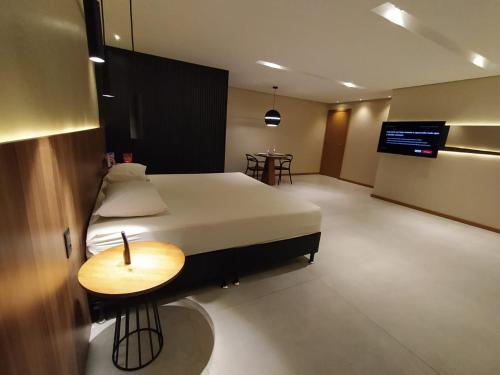 a bedroom with a bed and a table in it at Motel UP (Adult Only) in Fortaleza