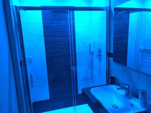 a bathroom with a glass shower and a sink at YourHome - La Meta Perfetta Rooms&Spa in Meta