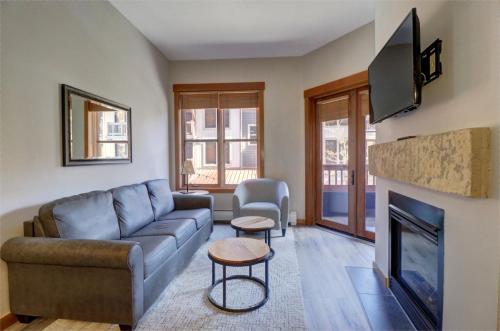 a living room with a couch and a fireplace at Co204 Copper One Lodge Condo in Copper Mountain
