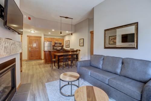 a living room with a blue couch and a table at Co204 Copper One Lodge Condo in Copper Mountain