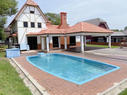 a large swimming pool in front of a house at Villa with Private Swimming Pool in Melaka