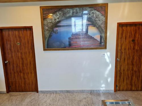a room with two doors and a picture on the wall at Vijay Shree Inn in Vellore