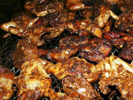 a pile of food that is being cooked at J Ochi ApartHotel in Ocho Rios