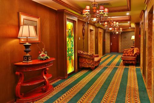 a hallway in a hotel with a table and chairs at Diplomat Hotel by AG Hotels Group in Astana