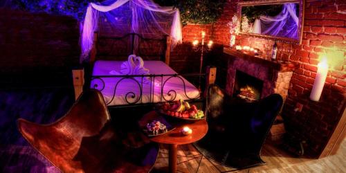 a room with a bed and a table with food on it at BIRDIE Pension & Wellness in Pardubice