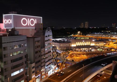 a lit up sign on top of a building at night at APA Hotel Ueno Ekimae in Tokyo
