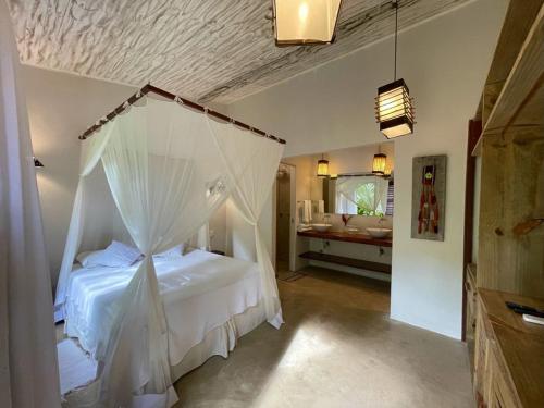 a bedroom with a bed with a mosquito net at Villa de Bemposta-Trancoso in Trancoso