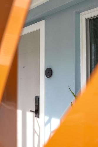 a white door with a knob on a window at The Saint Hotel in St Pete Beach