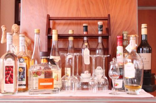 a bunch of bottles and glasses on a table at Hotel Vinum in Niederwurschnitz