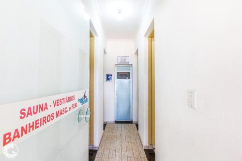 a hallway with a blue door in a building at Pousada das Estrelas Atibaia in Atibaia