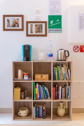 a wooden book shelf filled with books at Casa dell'Aromatario b&b in Sciacca