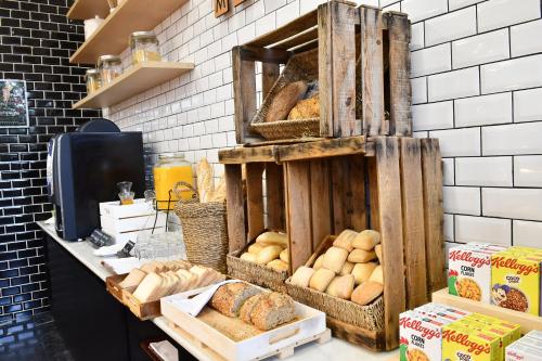 a bakery with lots of different types of bread at Holiday Inn Madrid - Las Tablas by IHG in Madrid
