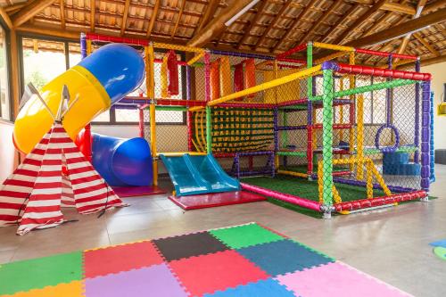 a childrens play area with a slide and a playground at Hotel Chalés Capitanias in Águas de Lindóia