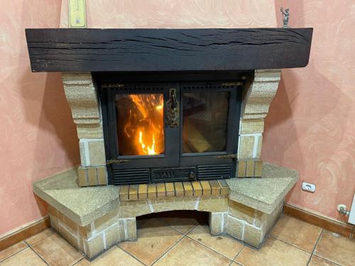 a fireplace with a fire inside of it at Casa La Fuente in Huércanos