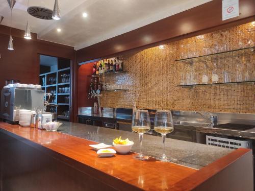 a kitchen with two glasses of wine on a counter at Hotel Sporting Trento in Trento
