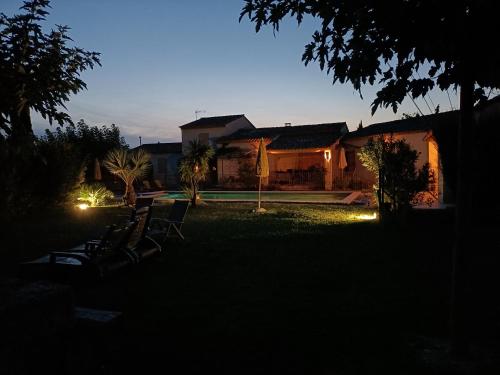 a house with lights in the yard at night at Le faré tchanqué chambre d'hôtes, parking gratuit sur place in Cavaillon