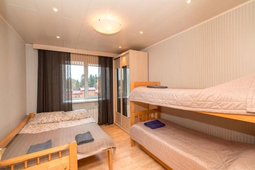 a bedroom with two bunk beds and a window at Family apartments in Sortavala