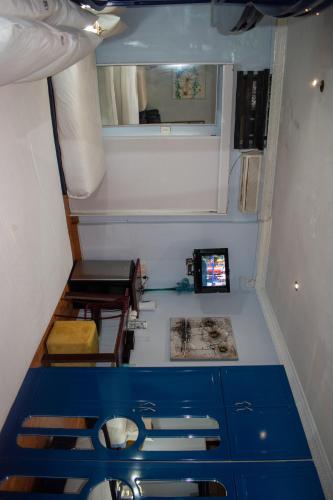 a small room with blue cabinets and a mirror at Lenasia Guest Lodge in Lenasia