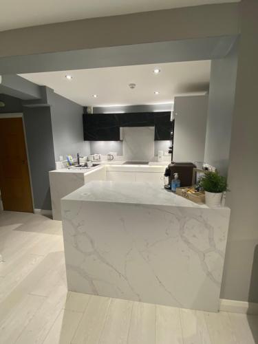 a kitchen with a marble counter top in a room at Ocean Hideaway @ Portmore Bay in Portstewart
