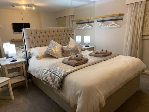 a bedroom with a large bed with two pillows on it at Ocean Hideaway @ Portmore Bay in Portstewart