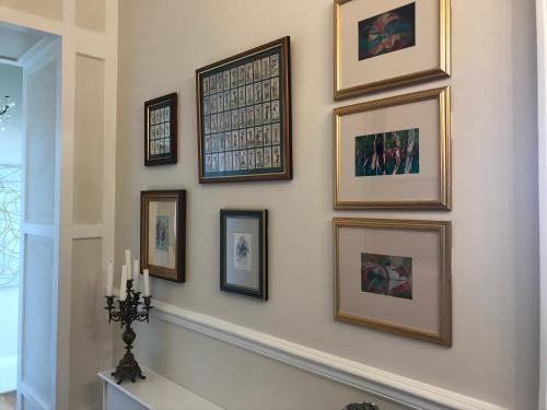 a group of framed pictures on a wall at The Leas View in Folkestone