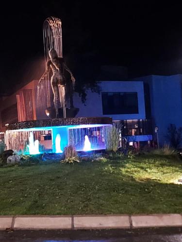 a statue in front of a building at night at Vrnjačka Banja Apartman in Vrnjačka Banja