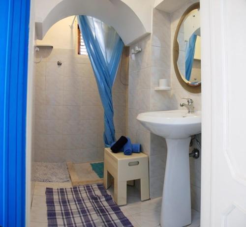 a bathroom with a sink and a mirror at Casa Cipolla in San Vito lo Capo