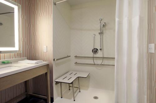 a bathroom with a shower and a toilet and a sink at Holiday Inn Hattiesburg - North, an IHG Hotel in Hattiesburg