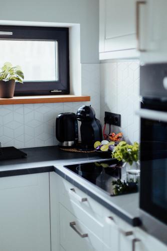 a kitchen with a sink and a stove top oven at atPUUTA in Saulkrasti
