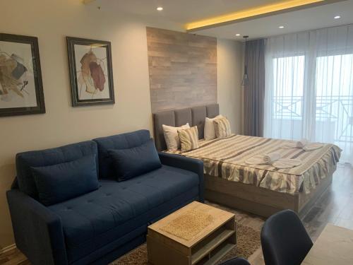 a living room with a bed and a couch at Milmari Premier40 in Kopaonik