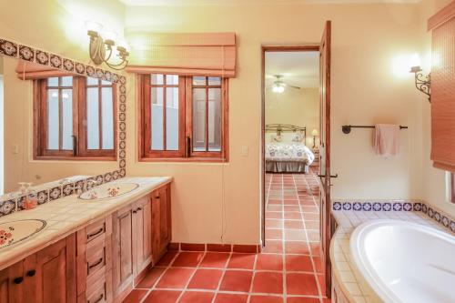 a bathroom with two sinks and a bath tub at Casa Chica FN320 at Loreto Bay in Loreto