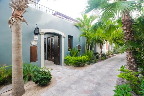 a house with a palm tree and a walkway at Casa Chica FN320 at Loreto Bay in Loreto