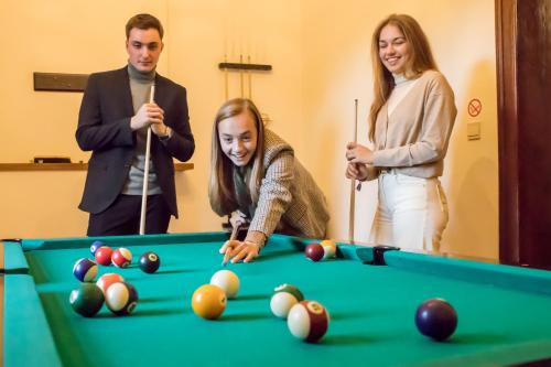 a group of people playing a game of pool at Château-ferme des Abys in Paliseul