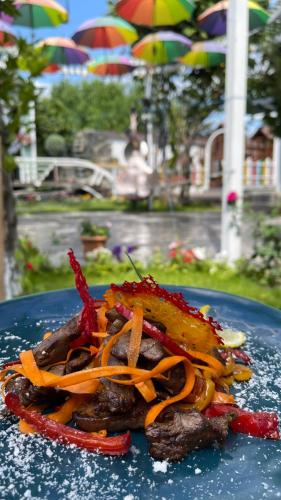 a blue plate with a piece of food on it at Qafqaz Fountain Villa in Gabala