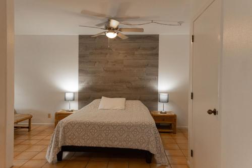 a bedroom with a bed and a ceiling fan at Puu Koa Palms vacation rental in Haiku