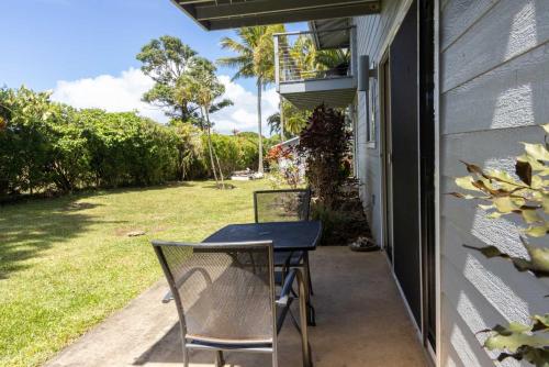 a table and chairs on the porch of a house at Puu Koa Palms vacation rental in Haiku