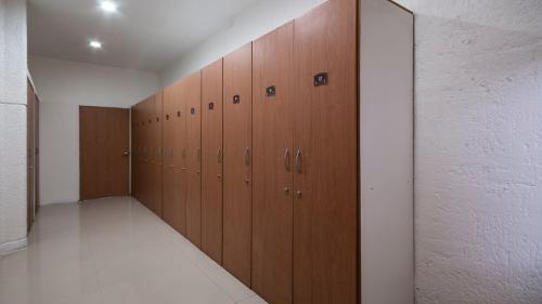 a row of wooden lockers in a room at Staybridge Suites Guadalajara Expo by IHG in Guadalajara
