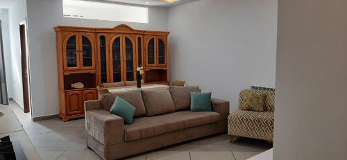 a living room with a couch and a chair at FUFA Haute standing appartment S2 center Monastir in Monastir