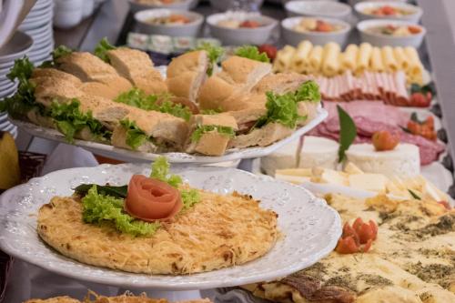 a table with plates of food on top at Hotel Gramado Interlaken in Gramado