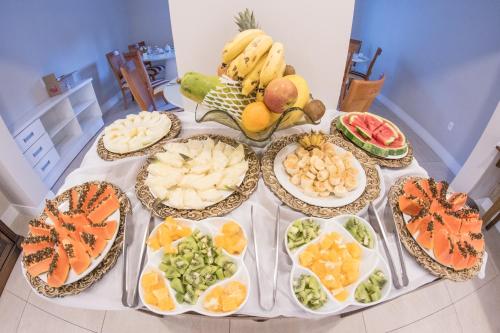 a table filled with different types of fruits and vegetables at Hotel Gramado Interlaken in Gramado