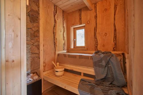 a sauna with a window in a wooden cabin at Chalet Weiberle Hochschwab in Etmissl